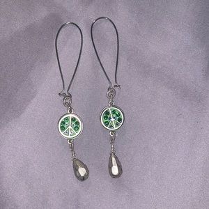 Handmade green and sliver peace sign earrings.